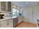 Well-lit kitchen with white cabinets, stainless steel appliances, and decorative backsplash at 6020 Quail St, Arvada, CO 80004