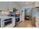 Updated kitchen features stainless steel appliances and stone countertops at 6020 Quail St, Arvada, CO 80004