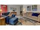 Comfortable living room with a sofa and arm chair atop a multi-toned area rug at 6020 Quail St, Arvada, CO 80004