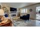 Bright living room with a modern fireplace, large-screen TV, and an inviting front entry at 6020 Quail St, Arvada, CO 80004