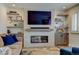 Inviting living room boasts a modern fireplace, large-screen TV, and decorative shelving at 6020 Quail St, Arvada, CO 80004