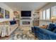Bright and airy living room with a modern fireplace, comfortable seating, and ample natural light at 6020 Quail St, Arvada, CO 80004