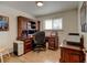 Office features wood floors, one window, and a built-in desk and shelving at 6020 Quail St, Arvada, CO 80004