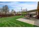 Outdoor patio area with green lawn, covered patio, and outdoor seating perfect for relaxation and entertaining at 6020 Quail St, Arvada, CO 80004
