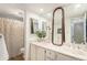 Bathroom featuring double sinks, marble vanity, large mirror, and a shower with a curtain at 7250 Eastmoor Dr # 203, Denver, CO 80237