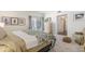 Cozy bedroom featuring neutral tones, a comfortable bed, and sliding door access to a private balcony at 7250 Eastmoor Dr # 203, Denver, CO 80237