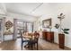 Dining room with wood floors, a round wood table, and access to an outdoor deck at 7250 Eastmoor Dr # 203, Denver, CO 80237