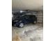 Attached garage featuring parking for two cars, shelving and a garage door at 7250 Eastmoor Dr # 203, Denver, CO 80237