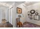 Hallway with wood floors, white walls, coat closet, and decorative mirrors and pictures at 7250 Eastmoor Dr # 203, Denver, CO 80237