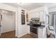 Compact kitchen features white cabinets and stainless steel appliances at 7250 Eastmoor Dr # 203, Denver, CO 80237