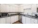 Bright kitchen with white cabinets, stainless steel appliances, and modern countertops at 7250 Eastmoor Dr # 203, Denver, CO 80237