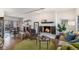 Cozy living room boasts a fireplace and an open floor plan into dining area at 7250 Eastmoor Dr # 203, Denver, CO 80237