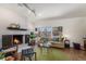 Bright living room with a fireplace, large window, and comfortable seating at 7250 Eastmoor Dr # 203, Denver, CO 80237