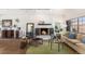 Cozy living room with a brick fireplace, wood floors, modern decor, and large window at 7250 Eastmoor Dr # 203, Denver, CO 80237