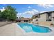Community swimming pool surrounded by lounge chairs and well-maintained landscaping at 7250 Eastmoor Dr # 203, Denver, CO 80237