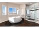 Luxurious bathroom with soaking tub, walk-in shower, and marble tile at 774 Chamberlain Way, Highlands Ranch, CO 80126