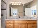 Bright bathroom with granite countertop, light wood cabinets, and shower at 774 Chamberlain Way, Highlands Ranch, CO 80126