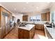 Spacious kitchen featuring a large island, stainless steel appliances, and ample cabinetry at 774 Chamberlain Way, Highlands Ranch, CO 80126