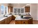 Modern kitchen with island, stainless steel appliances, and hardwood floors at 774 Chamberlain Way, Highlands Ranch, CO 80126