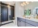 Modern bathroom with double vanity and hexagon tile shower at 1714 Peak Loop, Broomfield, CO 80023