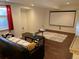 Finished basement featuring a home theater setup with a projector and screen for entertainment at 16119 E Prentice Ln, Centennial, CO 80015