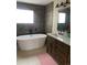 Bathroom showcases a soaking tub, vanity with countertop, and modern fixtures at 16119 E Prentice Ln, Centennial, CO 80015