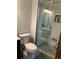 A bathroom featuring a white toilet and a glass-enclosed shower with white subway tile and a built-in niche at 16119 E Prentice Ln, Centennial, CO 80015