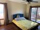 Bedroom with a large window and sliding glass door to the backyard at 16119 E Prentice Ln, Centennial, CO 80015