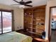 Bedroom featuring a built-in bookshelf, hardwood floors, and a ceiling fan at 16119 E Prentice Ln, Centennial, CO 80015