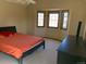 A bedroom with a bed, a dresser, and a bay window that provides natural light at 16119 E Prentice Ln, Centennial, CO 80015