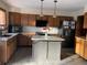 Kitchen with updated cabinets, stone countertops, and a center island at 16119 E Prentice Ln, Centennial, CO 80015