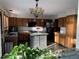 Spacious kitchen with a center island, wooden cabinets, and modern appliances at 16119 E Prentice Ln, Centennial, CO 80015