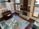 Bright living room with a stone fireplace, hardwood floors, and large windows at 16119 E Prentice Ln, Centennial, CO 80015