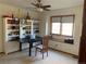 Home office featuring a large window, black desk, and built-in shelving at 16119 E Prentice Ln, Centennial, CO 80015