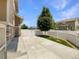 Backyard view featuring a concrete patio, well maintained lawn, white fencing, and mature landscaping at 2258 Whistler Dr, Longmont, CO 80504