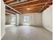 Unfinished basement featuring exposed ceiling, concrete floor, and two windows providing natural light at 2258 Whistler Dr, Longmont, CO 80504