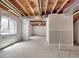 Unfinished basement showcasing a concrete floor, exposed ceiling with beams and insulated walls at 2258 Whistler Dr, Longmont, CO 80504