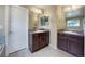 Bathroom featuring double vanity sinks, tiled floors and large mirrors for comfort and convenience at 2258 Whistler Dr, Longmont, CO 80504
