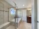Bathroom with a large soaking tub and tiled walk-in shower with seamless glass door at 2258 Whistler Dr, Longmont, CO 80504