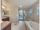 Bathroom featuring soaking tub, glass-enclosed shower, and vanity at 2258 Whistler Dr, Longmont, CO 80504