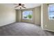 Bedroom with carpet, ceiling fan and large window allowing lots of natural light at 2258 Whistler Dr, Longmont, CO 80504