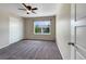 Carpeted bedroom with ceiling fan and window overlooking the neighborhood at 2258 Whistler Dr, Longmont, CO 80504