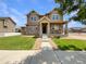 Charming two-story home featuring stone accents, a well-manicured lawn, and inviting front porch at 2258 Whistler Dr, Longmont, CO 80504
