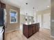 Kitchen with center island featuring stone countertops and stainless steel appliances, with view to breakfast area at 2258 Whistler Dr, Longmont, CO 80504