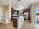 Bright kitchen features stainless steel appliances, granite countertops, hardwood floors and center island with pendant lighting at 2258 Whistler Dr, Longmont, CO 80504