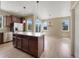 Kitchen includes center island with stone countertops, stainless steel appliances and views into breakfast nook and back yard at 2258 Whistler Dr, Longmont, CO 80504