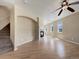 Open-concept living room with beautiful hardwood floors, fireplace, staircase and plenty of natural light at 2258 Whistler Dr, Longmont, CO 80504