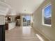 Open-concept living space flowing into the kitchen, featuring hardwood floors and abundant natural light at 2258 Whistler Dr, Longmont, CO 80504
