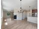 Spacious open layout connecting the living area and kitchen, featuring hardwood floors and a modern fireplace at 2258 Whistler Dr, Longmont, CO 80504