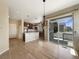 Stylish open-concept layout featuring hardwood floors, a pendant light, and a view of the modern kitchen at 2258 Whistler Dr, Longmont, CO 80504
